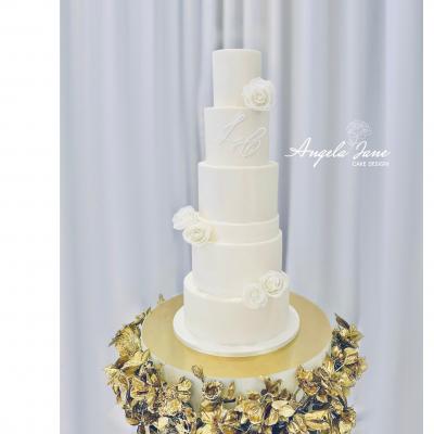 All white wedding cake with sugar roses